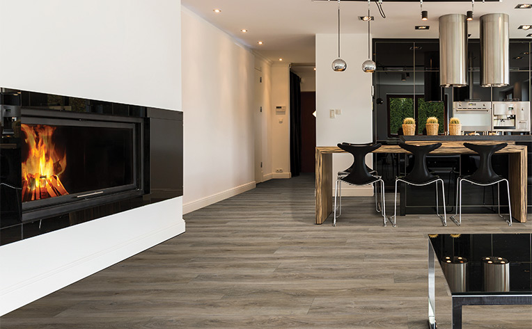 wood flooring in living room and kitchen with fireplace